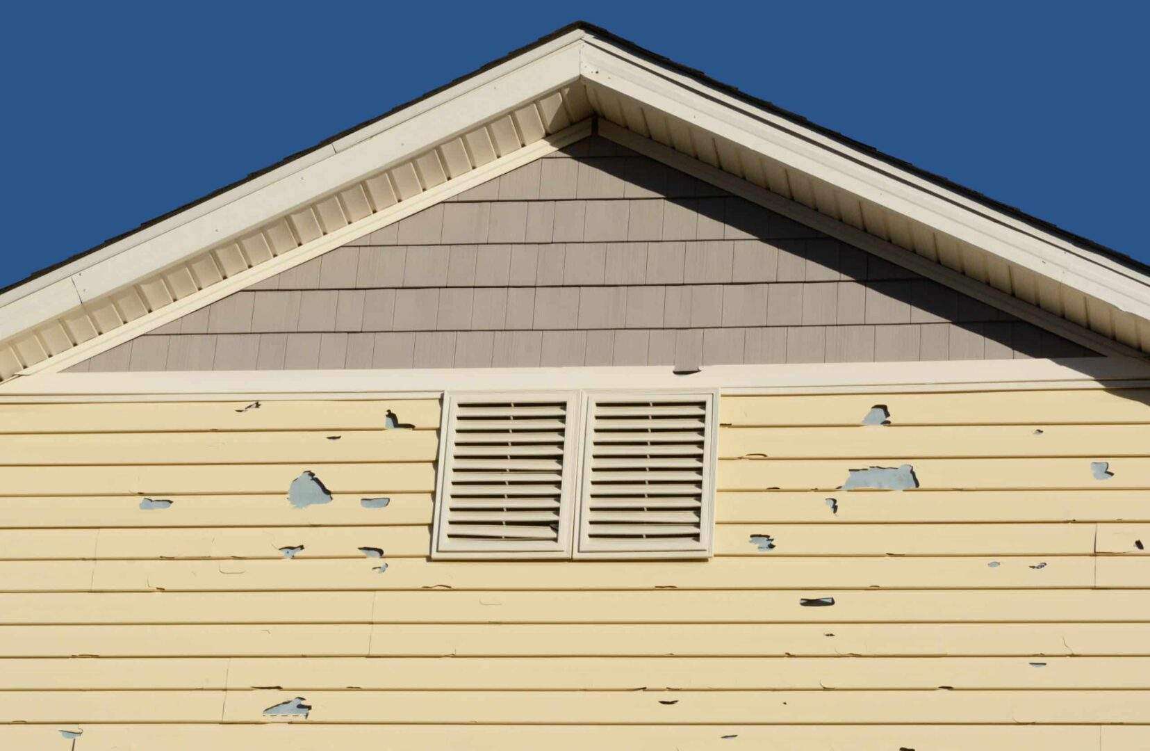 Holes in exterior siding in home from damage by hail storm
