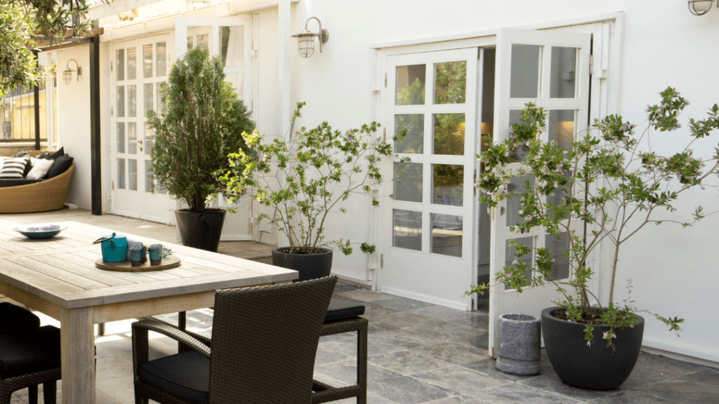 tables and chairs outside of a house