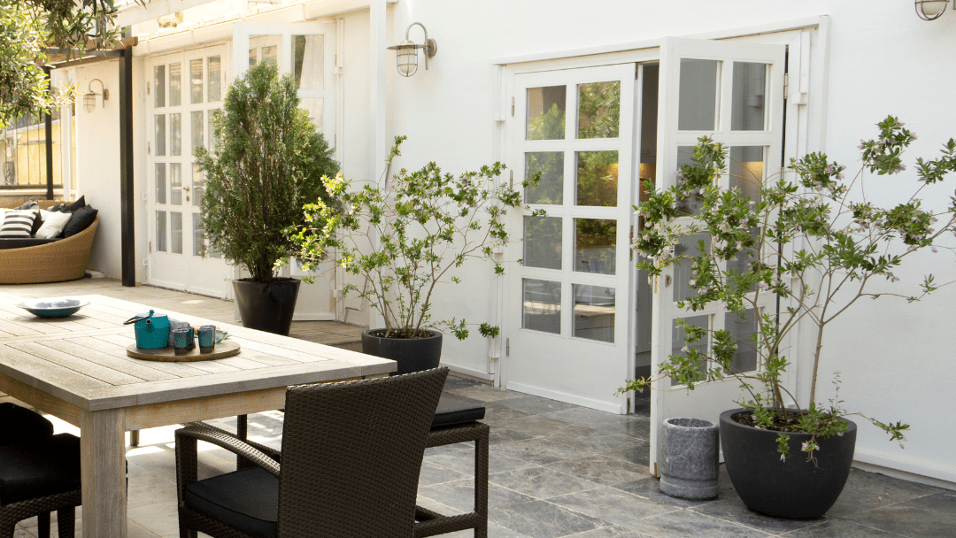 tables and chairs outside of a house