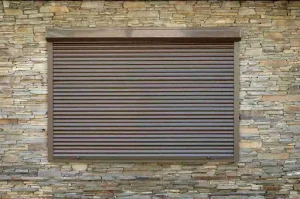 Fully closed roll-down hurricane shutter over window, illustrating security features in accordion vs roll-down hurricane shutters.