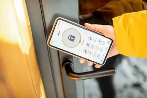 Smartphone unlocking a modern entry door, reflecting Front Door Trends focused on smart locks, security, and connected access.